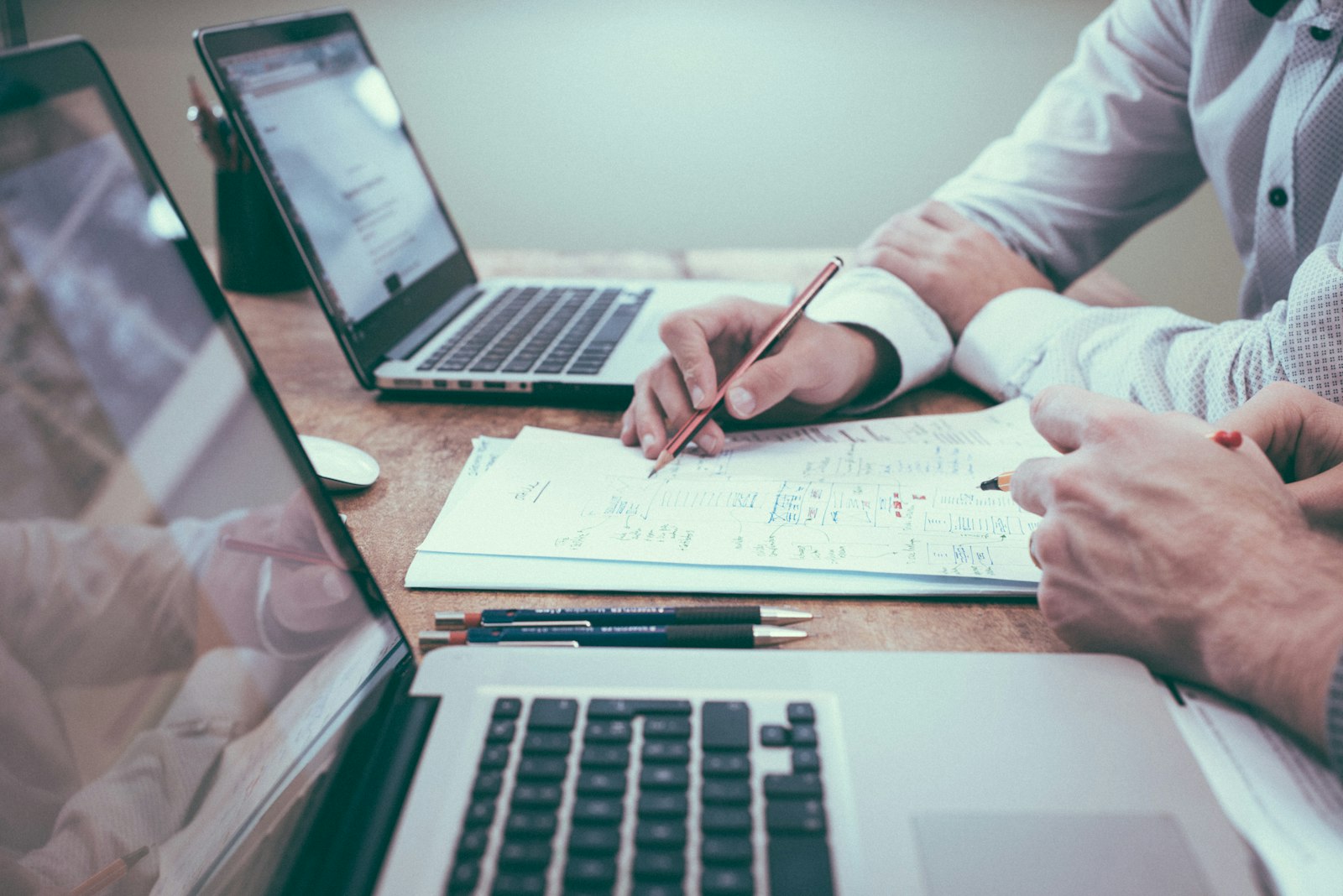 Professional reviewing business documents and paperwork at an office desk